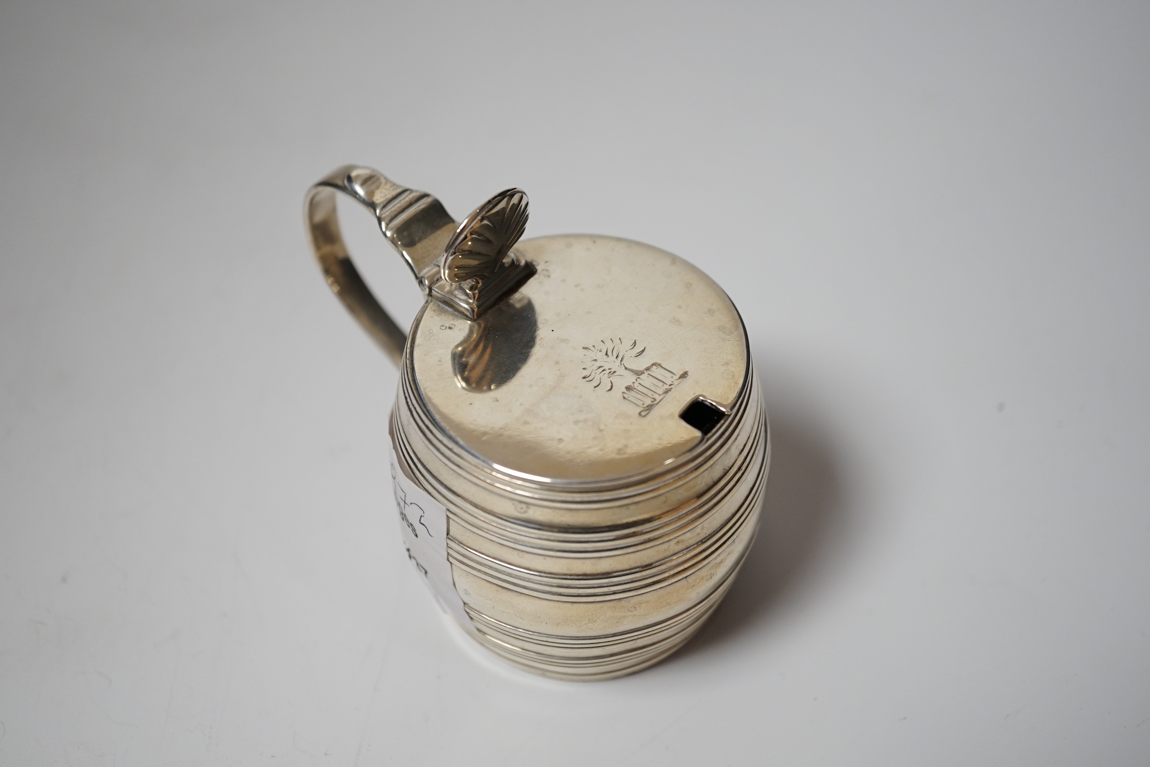 A George III silver barrel shaped mustard pot, Thomas Daniell, London, 1780, 8cm, with later blue glass liner.